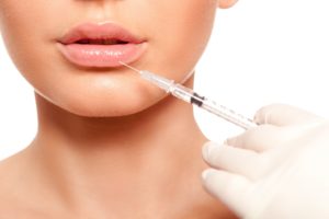 Beautiful woman face getting syringe injection on lips | Luz MediSpa in Somers, NY